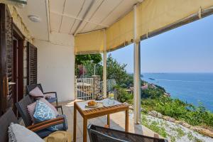 a patio with a table and a view of the ocean at Sunset Oasis in Dubrovnik