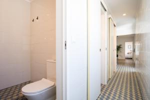 a bathroom with a toilet and a walk in shower at Beautiful Boutique House Near the Beach in Costa da Caparica +63 photos