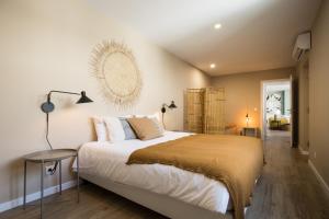 a bedroom with a bed and a mirror on the wall at Beautiful Boutique House Near the Beach in Costa da Caparica