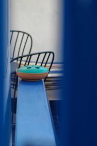 a surfboard sitting on top of a table with two chairs at Affittacamere Angelica in Bacoli