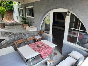 einen Tisch und Stühle auf der Terrasse eines Hauses in der Unterkunft Hiša odprtih vrat in Tolmin