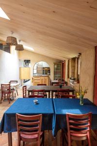 a dining room with a blue table and chairs at Auberge de Lascours in Ceilhes-et-Rocozels