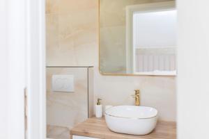 a bathroom with a white sink and a mirror at Turta Rooms in Zadar