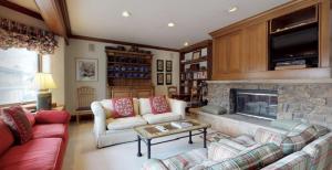 a living room with two couches and a fireplace at Vail Village Plaza Lodge 3 Bedroom Condo in Vail