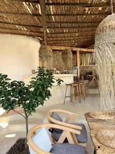 a room with a tree and chairs and a table at Le Rêve Boutique Hotel in Dhërmi