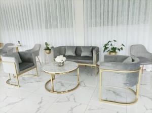 a living room with a couch and chairs and a table at Golden Nest Hotel Suvarnabhumi in Bangkok