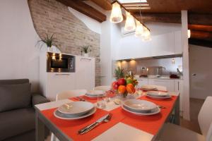 a kitchen with a table with a red table cloth at City Apartments Rialto Market in Venice