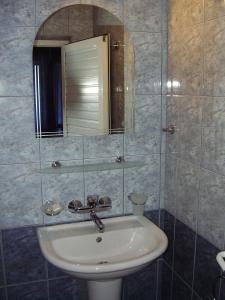 a bathroom with a sink and a mirror at Sea House Guest House in Nesebar
