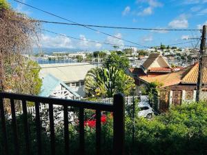 a view of a city from the balcony of a house at Chambre d'hôtes Sunset Bas du Fort in Le Gosier