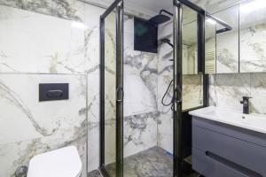 a bathroom with a shower and a sink at Comfy and Central Flat in the Heart of Sisli in Istanbul