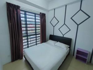 a bedroom with a white bed and a large window at Golden Hills Pasar Malam 3 Bedroom Apartment J LouvRe in Tanah Rata
