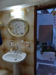 La salle de bains est pourvue d'un lavabo et d'un miroir. dans l'établissement MATAS HOUSE, à Leonidio