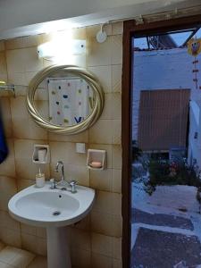 a bathroom with a sink and a mirror at MATAS HOUSE in Tiros