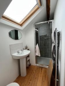 a bathroom with a sink and a shower at The Hayloft in Hereford