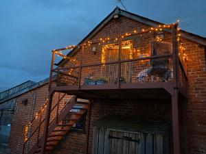 a building with a staircase with lights on it at The Hayloft in Hereford