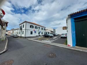 an empty street with cars parked on the street at Santa Luzia Center in Ribeira Grande
