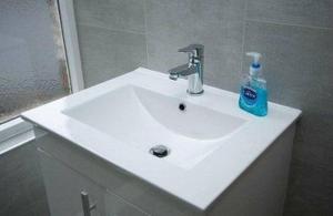 a white sink with a blue soap bottle on it at AMAZING 3 BEDROOM HOME, PRIME BT1 POSTCODE AND CITY CENTRE LOCATION in Belfast