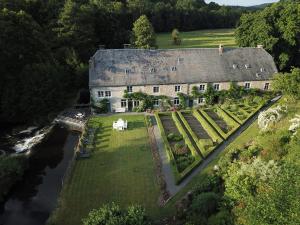 an aerial view of a large house with a garden at B&B Le Moulin de Resteigne in Resteigne