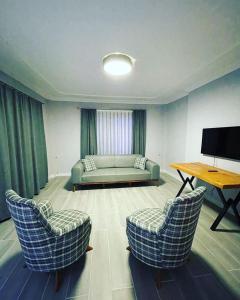 sala de estar con sofá y 2 sillas en 2 bedroom flat with swimming pool for rent mazi village of bodrum, en Bodrum City