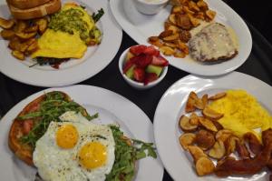 a table with plates of breakfast food on it at The Pines Resort & Conference Center in Bass Lake