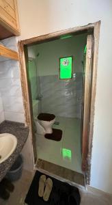 a bathroom with a toilet and a sink at Oak Farm مزرعة الملّول in Ajloun