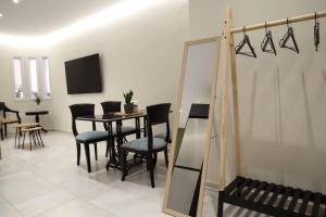 a dining room with a table and chairs and a mirror at Eclectic Apartment near Downtown in Heraklio