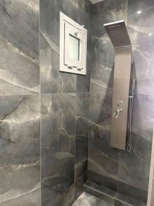 a shower stall with a phone on the wall at Eclectic Apartment near Downtown in Heraklio