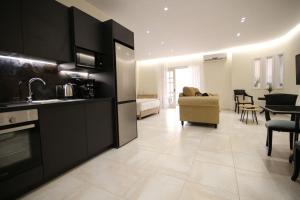 a kitchen and living room with a couch and a table at Eclectic Apartment near Downtown in Heraklio