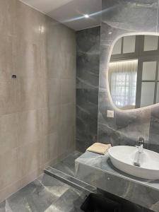 a bathroom with a sink and a mirror at Eclectic Apartment near Downtown in Heraklio