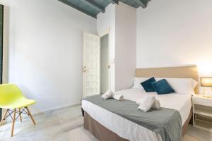 Łóżko lub łóżka w pokoju w obiekcie Casa en el Centro de Sevilla