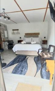 a bedroom with a bed and a rug at Revive Self catering unit in Darling