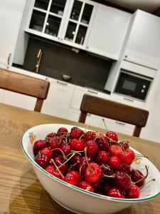 a bowl of cherries sitting on a table in a kitchen at La Casina de la Yeye San Cristóbal de Valdueza in San Cristóbal de Valdueza