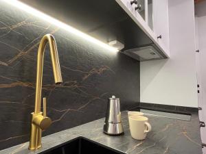 a kitchen counter with a sink and a faucet at La Casina de la Yeye San Cristóbal de Valdueza in San Cristóbal de Valdueza +108 photos