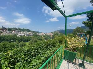 a green balcony with a bench and a playground at Hotel Skilift - Dada Hotels in Frabosa Soprana