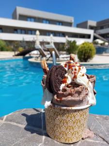 a ice cream cone with a oreo cookie and whipped cream at Complex Casa Ani in Eforie Nord