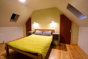 a bedroom with a bed with a yellow bedspread at Tarset Tor - Bothy Cabin 4 in Hexham