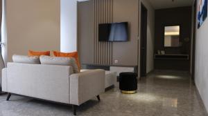 un soggiorno con divano e TV di Lun Hotel Manado a Manado