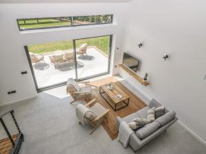 an overhead view of a living room with a table and chairs at Tilia Barn in Wincanton