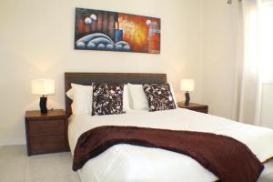 a bedroom with a large bed with two night stands at Villa Amina in Puerto del Carmen