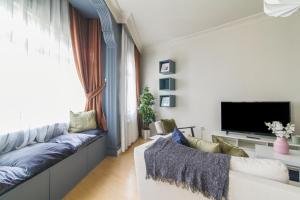 a living room with a couch and a tv at Chic and Cozy Flat Near Istiklal Street in Beyoglu in Istanbul