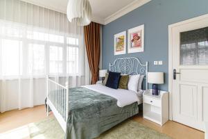 a bedroom with a white bed and blue walls at Chic and Cozy Flat Near Istiklal Street in Beyoglu in Istanbul