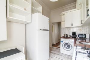 a kitchen with a white refrigerator and a washing machine at Chic and Cozy Flat Near Istiklal Street in Beyoglu in Istanbul