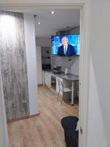 ein Wohnzimmer mit einem Schreibtisch und einem TV in der Unterkunft Céntrico apartamento con patio in Madrid
