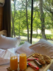 a tray of food and two glasses of orange juice at Lightwood cabins in Kʼareli