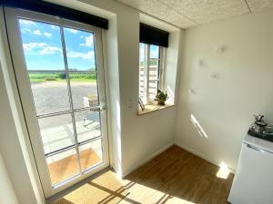 an empty room with a door to a balcony at Bøgelund Sleep-in in Karup