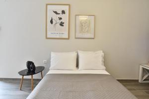 a bedroom with a bed and two pictures on the wall at Comfort Spot 1 in Kavala