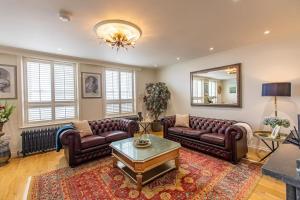 a living room with leather furniture and a mirror at The View in Ramsgate