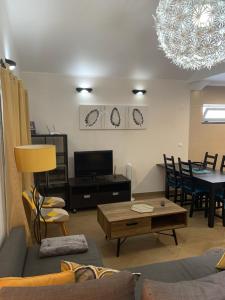 a living room with a couch and a table at casa da rochinha in Lajes do Pico