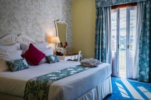 a bedroom with a large bed and a window at The Vintage House - Douro in Pinhão