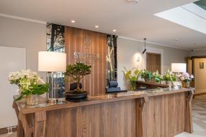 a flower shop with a counter with flowers on it at STORIES Design ApartHotel in Jūrmala